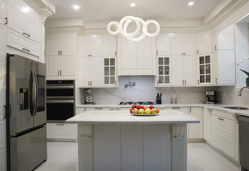 Classic white kitchen renovation in Toronto with marble backsplash