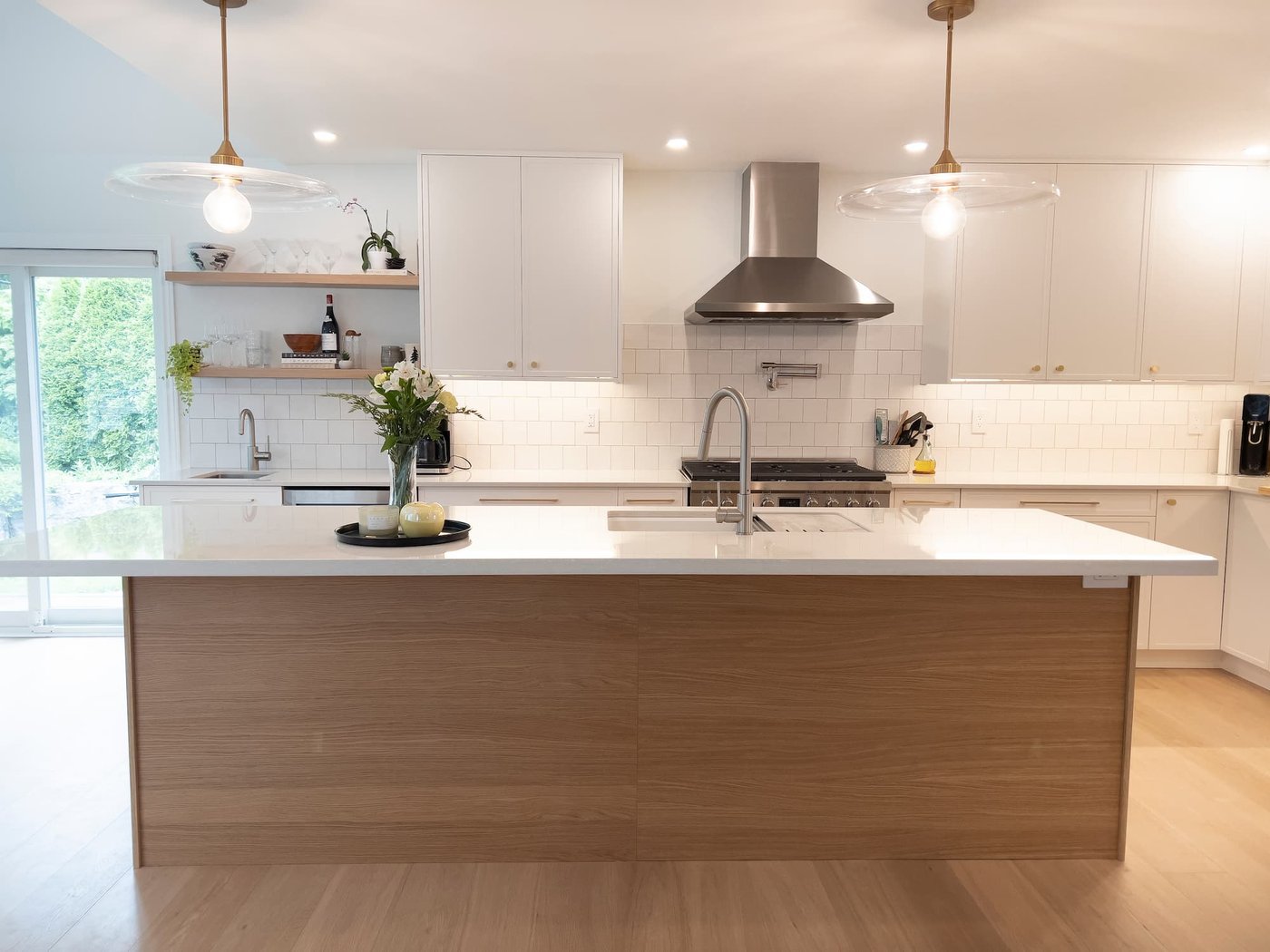 Modern kitchen renovation in Toronto by Easy Afford with white cabinets, wood island, and quartz countertop