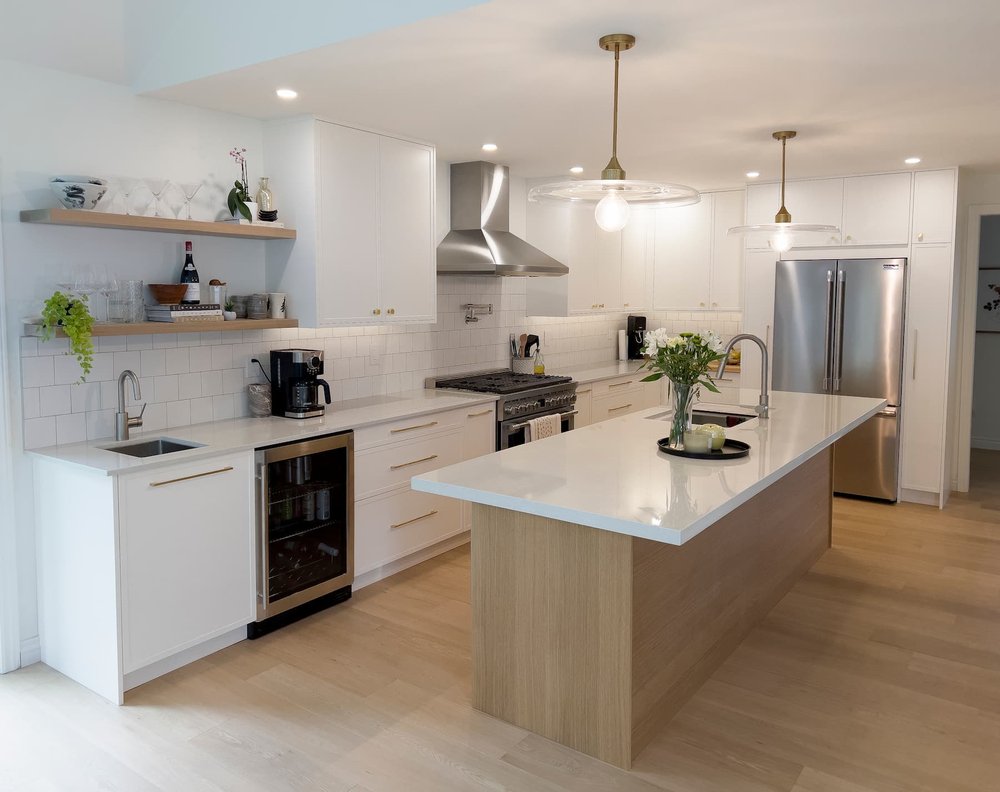 White kitchen renovation in Toronto with wood island and quartz countertop